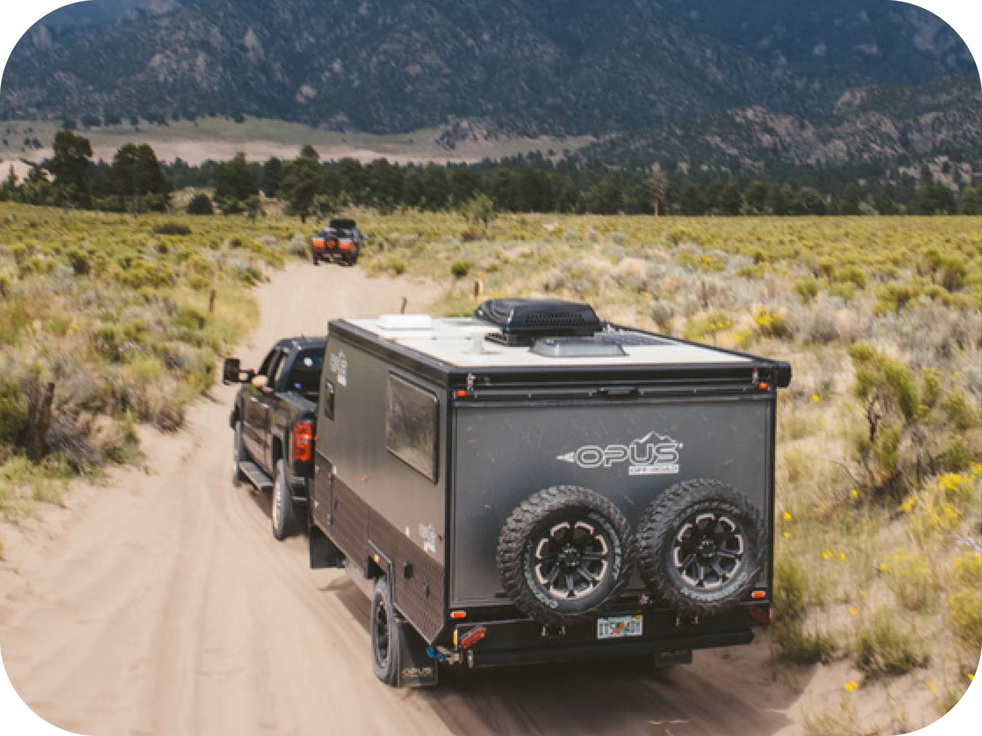 Off road camper towing on dirt road OPUS Camper